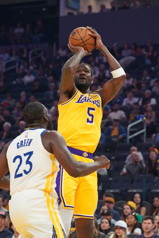 Oct 5, 2025; San Francisco, California, USA; Los Angeles Lakers center Deandre Ayton (5) shoots over Golden State Warriors forward Draymond Green (23) in the first quarter at Chase Center. Mandatory Credit: David Gonzales-Imagn Images
