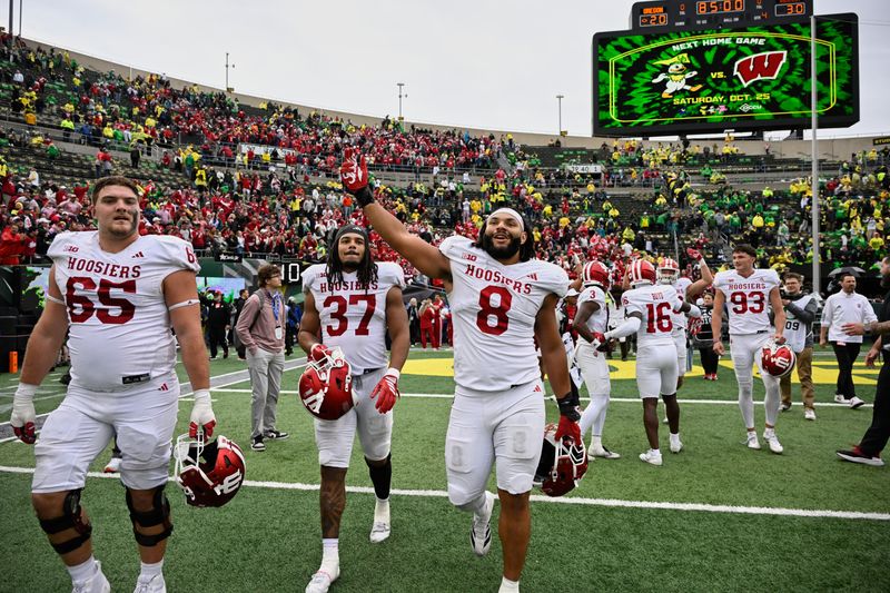 Indiana defensive lineman Stephen Daley (8), tight end Riley Nowakowski (37) and offenive lineman Carter Smith (65) celebrate on the field after the team's defeat of Oregon at Autzen Stadium.