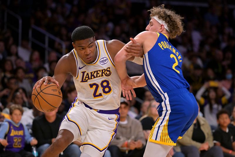 Oct 12, 2025; Los Angeles, California, USA; Los Angeles Lakers forward Rui Hachimura (28) is defended by Golden State Warriors guard Brandin Podziemski (2) during the first half at Crypto.com Arena. Mandatory Credit: Jayne Kamin-Oncea-Imagn Images