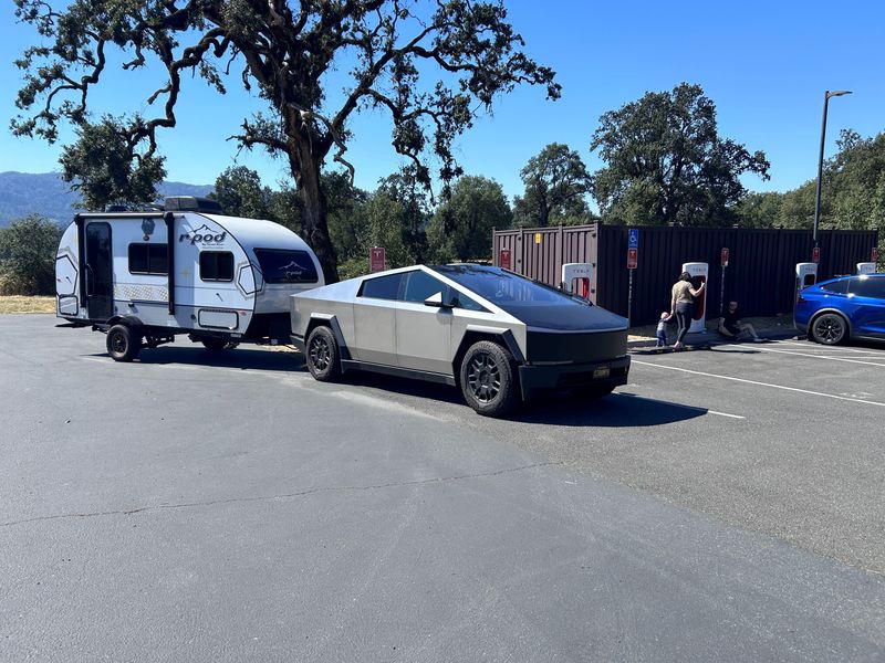 Kent Bullard takes his Tesla Cybertruck and camper at a campground charger in Laytonville, California.