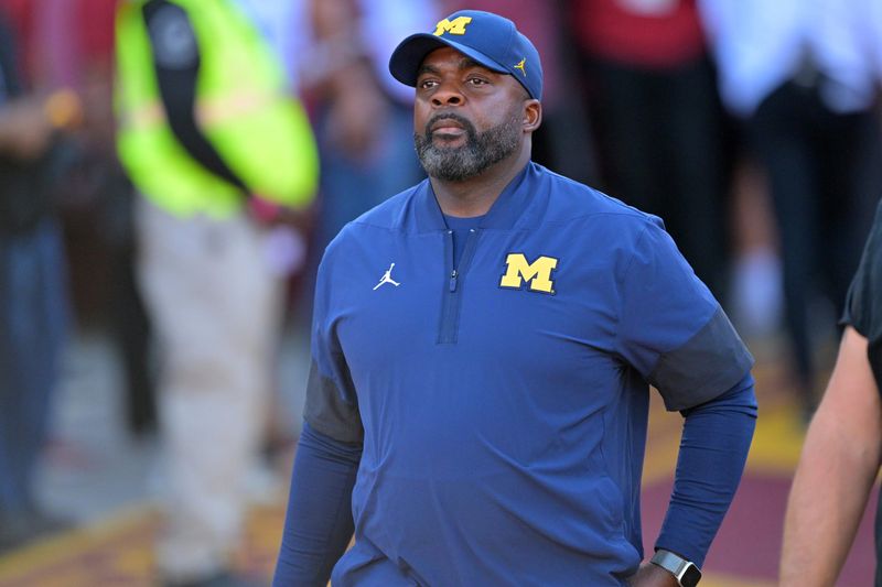 Oct 11, 2025; Los Angeles, California, USA; Michigan Wolverines head coach Sherrone Moore heads on to the field for the game against the USC Trojans at United Airlines Field at the Los Angeles Memorial Coliseum. Mandatory Credit: Jayne Kamin-Oncea-Imagn Images