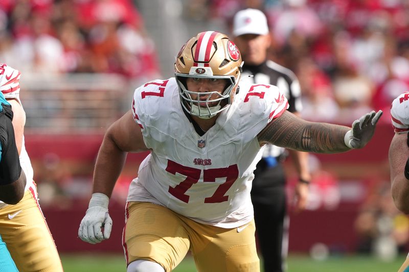 Sep 28, 2025; Santa Clara, California, USA; San Francisco 49ers offensive tackle Dominick Puni (77) during the third quarter against the Jacksonville Jaguars at Levi's Stadium. Mandatory Credit: Darren Yamashita-Imagn Images