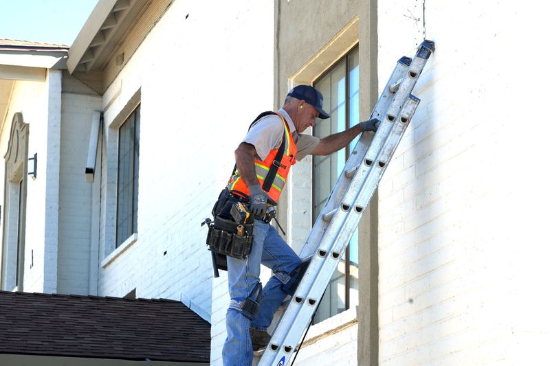 Will Jenson of Ventura installs front lights Oct. 16, 2025, at the former La Quinta Inn in Ventura, which is being renovated into 134 studio apartments for homeless residents. Now named Valentine Road Apartments, the project cost $77 million.