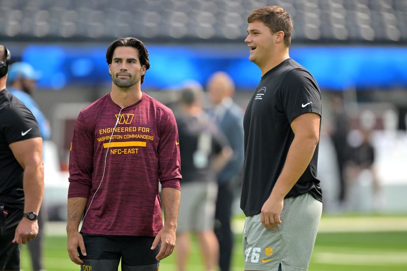 Oct 5, 2025; Inglewood, California, USA; Washington Commanders quarterback Sam Hartman (15) and Los Angeles Chargers offensive tackle Joe Alt (76), both played at Notre Dame, talk on the field prior to the game at SoFi Stadium. Mandatory Credit: Jayne Kamin-Oncea-Imagn Images
