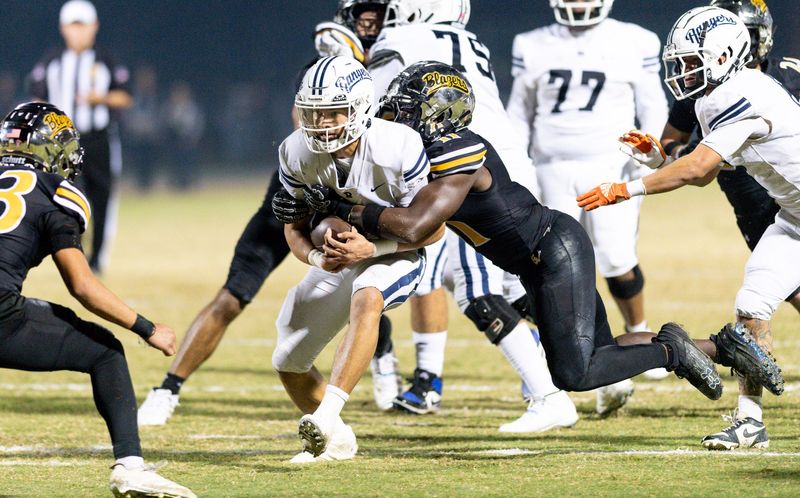 Golden West's Zalen Seals takes down Redwood quarterback Luke Sanchez in East Yosemite League high school football Friday, October 17, 2025