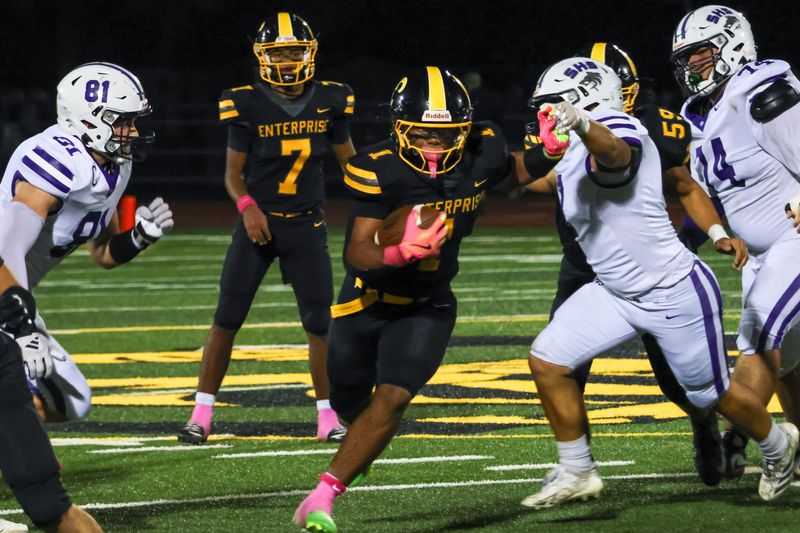 Enterprise running back Koby Johnson stiff arms a Shasta defender during the River Bowl. Johnson had a massive game with four touchdowns, and his Hornets claimed victory over their crosstown rivals. Oct. 17, 2025.
