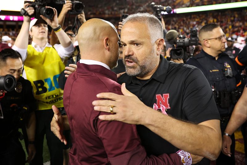 Oct 17, 2025; Minneapolis, Minnesota, USA; Nebraska Cornhuskers head coach Matt Rhule and Minnesota Golden Gophers head coach P.J. Fleck shake hands after the game at Huntington Bank Stadium. Mandatory Credit: Matt Krohn-Imagn Images