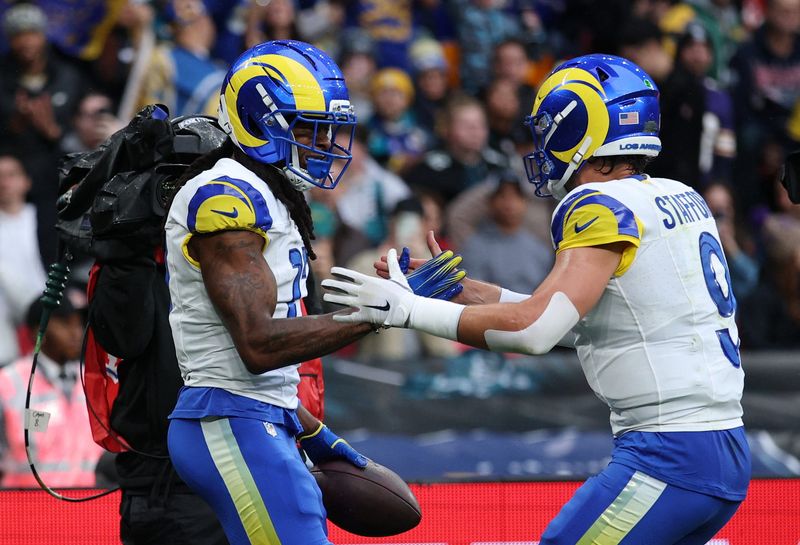 [US, Mexico & Canada customers only] Oct 19, 2025; London, United Kingdom; Los Angeles Rams wide receiver Davante Adams (17) celebrates with quarterback Matthew Stafford (9) after scoring a touchdown against the Jacksonville Jaguars during the first half during a NFL International Series game at Wembley Stadium. Mandatory Credit: Andrew Boyers-Reuters via Imagn Images