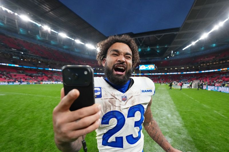 Oct 19, 2025; London, United Kingdom; Los Angeles Rams running back Kyren Williams (23) takes a video after their win against the Jacksonville Jaguars in an NFL International Series game at Wembley Stadium. Mandatory Credit: Kirby Lee-Imagn Images