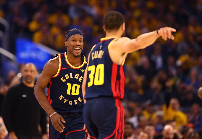 Apr 28, 2025; San Francisco, California, USA; Golden State Warriors forward Jimmy Butler III (10) celebrates towards guard Stephen Curry (30) after a basket against the Houston Rockets during the first quarter of game four of the 2025 NBA Playoffs first round at Chase Center. Mandatory Credit: Kelley L Cox-Imagn Images