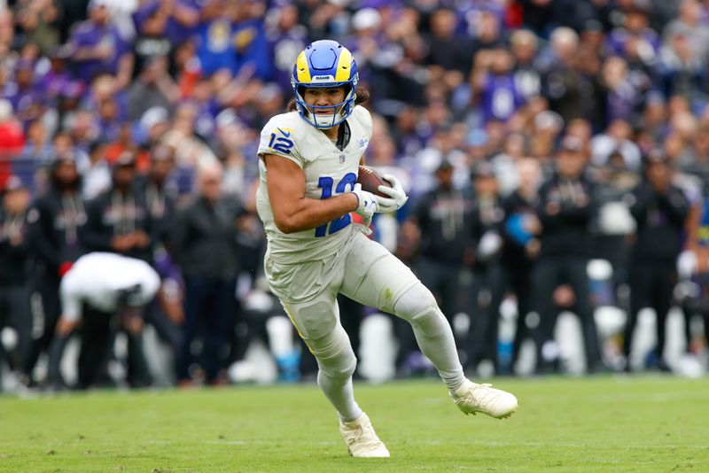 Oct 12, 2025; Baltimore, Maryland, USA; Los Angeles Rams wide receiver Puka Nacua (12) carries the ball against the Baltimore Ravens during the second quarter of the game at M&T Bank Stadium. Mandatory Credit: Peter Casey-Imagn Images