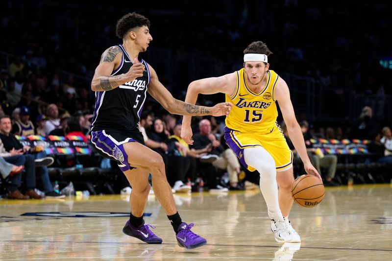 Oct 17, 2025; Los Angeles, California, USA; Los Angeles Lakers guard Austin Reaves (15) drives the ball against Sacramento Kings guard Nique Clifford (5) during the second half at Crypto.com Arena. Mandatory Credit: William Liang-Imagn Images