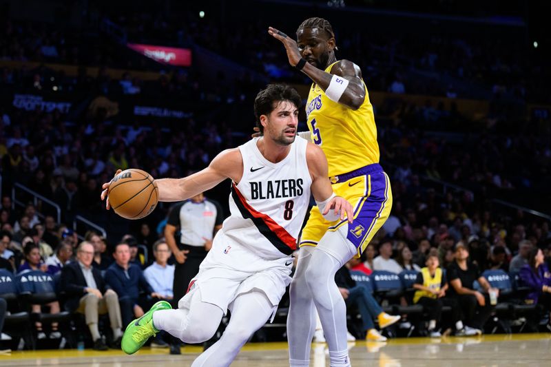 Oct 27, 2025; Los Angeles, California, USA; Portland Trail Blazers forward Deni Avdija (8) drives the ball while under pressure from Los Angeles Lakers center Deandre Ayton (5) during the first half at Crypto.com Arena. Mandatory Credit: William Liang-Imagn Images