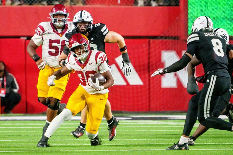 Nov 1, 2025; Lincoln, Nebraska, USA; Southern California Trojans running back King Miller (30) runs against the Nebraska Cornhuskers during the fourth quarter at Memorial Stadium. Mandatory Credit: Dylan Widger-Imagn Images