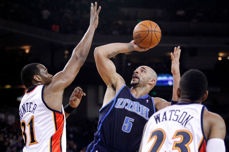 February 19, 2010; Sacramento, CA, USA; Utah Jazz forward Carlos Boozer (5) attempts a shot over Golden State Warriors center Chris Hunter (31) in the fourth quarter at ORACLE Arena. The Jazz defeated the Warriors 100-89. Mandatory Credit: Cary Edmondson-USA TODAY Sports