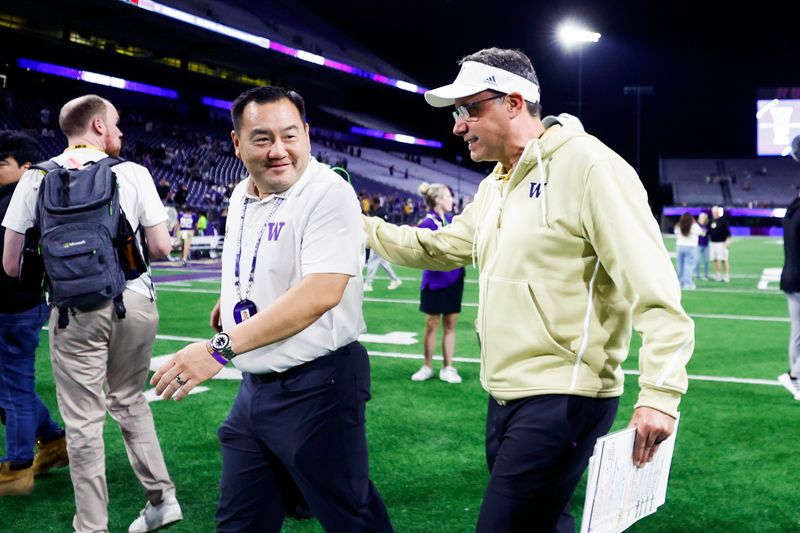Aug 31, 2024; Seattle, Washington, USA; Washington Huskies head coach Jedd Fisch, right, walks to the locker room with athletic director Pat Chun following a game against the Weber State Wildcats during the fourth quarter at Alaska Airlines Field at Husky Stadium. Mandatory Credit: Joe Nicholson-USA TODAY Sports