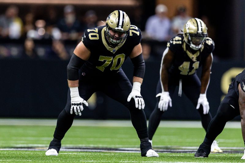 Sep 22, 2024; New Orleans, Louisiana, USA; New Orleans Saints offensive tackle Trevor Penning (70) looks on against the Philadelphia Eagles during the first half at Caesars Superdome. Mandatory Credit: Stephen Lew-Imagn Images