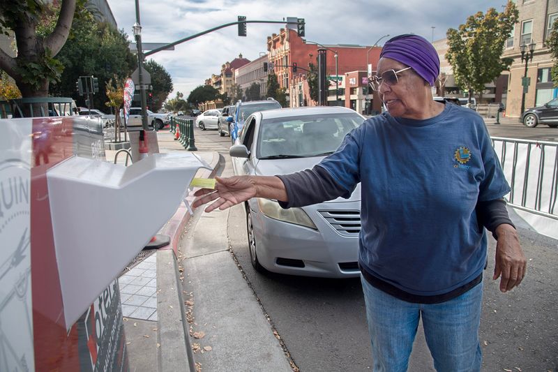Geraldine Eubanks places her ballot into a ballot box at the Registrar of Voters drive up ballot drop off in front of the San Joaquin County Administration Building in downtown Stockton on Nov. 4. 2025.