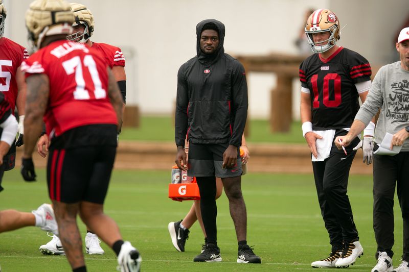 Jul 24, 2025; Santa Clara, CA, USA; San Francisco 49ers wide receiver Brandon Aiyuk (in black hoodie) watches his teammates work out during the second day of training camp. Mandatory Credit: D. Ross Cameron-Imagn Images