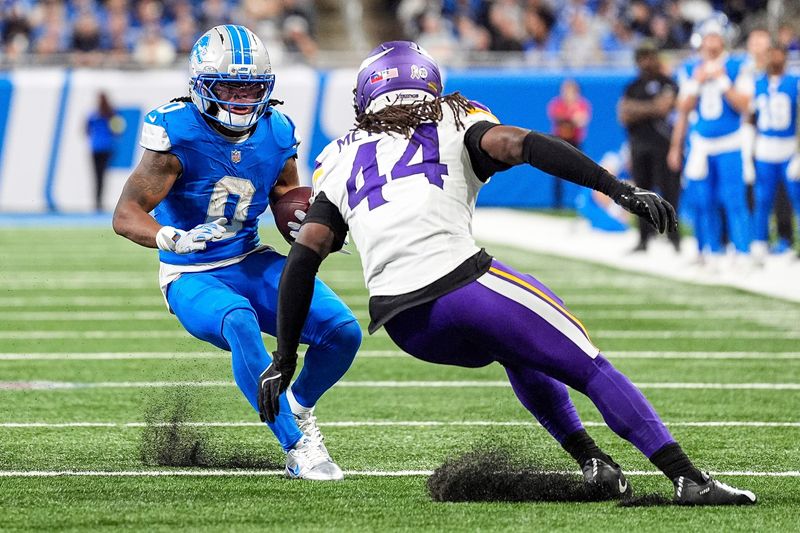 Detroit Lions running back Jahmyr Gibbs (0) runs against Minnesota Vikings safety Joshua Metellus (44) during the second half at Ford Field in Detroit on Sunday, November 2, 2025.