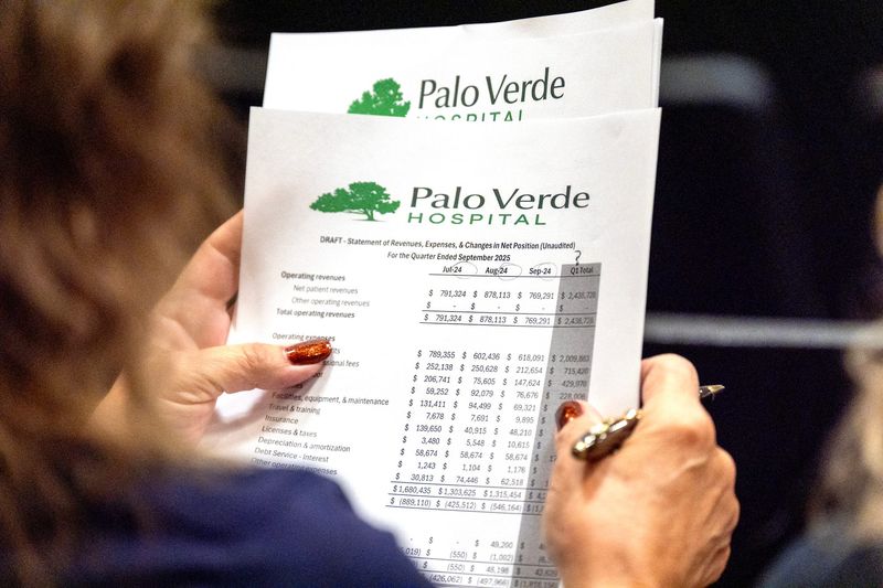 An attendee looks over a budget of revenue and expenses for Palo Verde Hospital during the Palo Verde Hospital District Board of Directors meeting in Blythe, Calif., on Oct. 29, 2025.