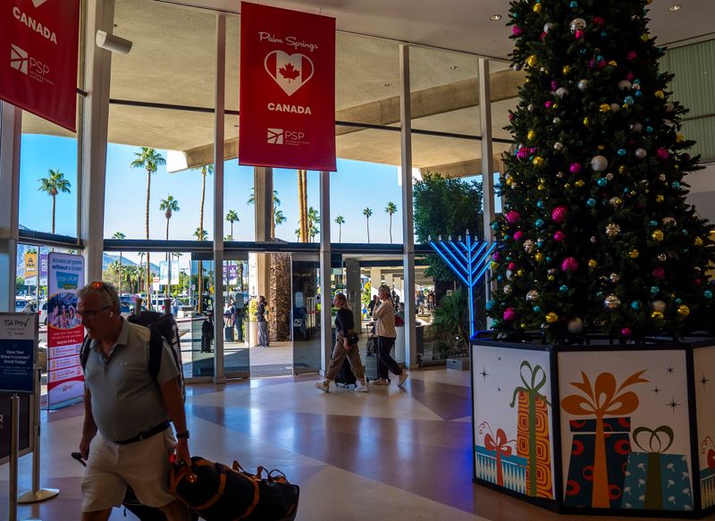 Travelers make their way out of the Palm Springs International Airport in Palm Springs, Calif., Thursday, Nov. 6, 2025.