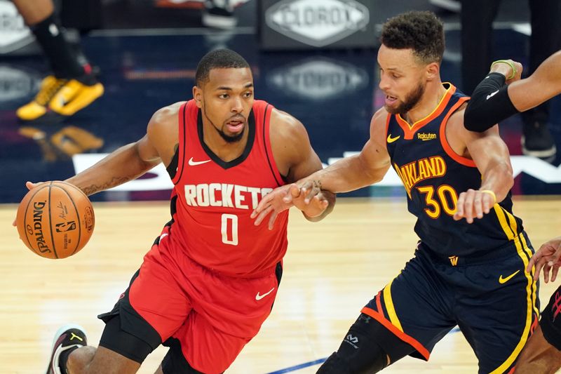 Apr 10, 2021; San Francisco, California, USA; Houston Rockets forward Sterling Brown (0) dribbles while being defended by Golden State Warriors guard Stephen Curry (30) during the first quarter at Chase Center. Mandatory Credit: Darren Yamashita-USA TODAY Sports