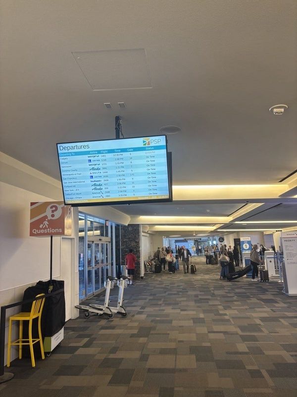 A departure board at Palm Springs International Airport on Friday at around 1 p.m. showed most flights were scheduled to depart on-time.