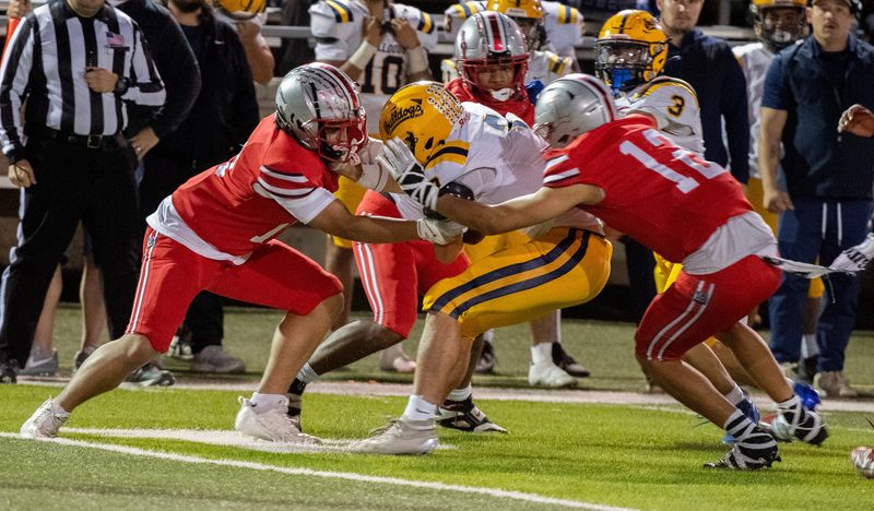 Lincoln’s Rylan Tuuaga, left, and Fallon Barquet tackle Turlock’s Armani Alvarado during the Sac-Joaquin Section football bowl game at Lincoln’s Spanos Stadium in Stockton on Nov. 7, 2025. Lincoln won 54-15.