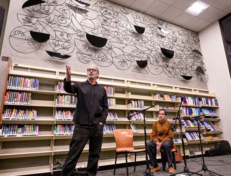 Sculptor Richie Vipham, left, and designer Aaron Gomes introduce the permanent installation behind them “Fruition” at the Visalia Branch Library on Friday, November 7, 2025.