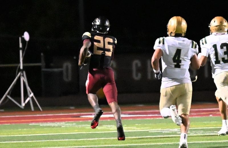 Oaks Christian's Christian Butler heads to the end zone ahead of St. Bonaventure's Jeremiah Barrios (4) and Jacob Montes (13) to score the go-ahead touchdown after catching a deflected pass in the Lions' 15-13 win in a CIF-Southern Section Division 4 first-round game on Friday, Nov. 7, 2025, at Oaks Christian.