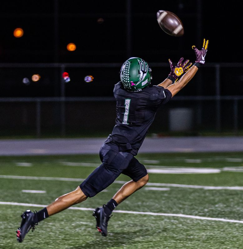 Pacifica's Anthony Jacobs Jr. stretches to make a catch before running into the end zone for a touchdown during the Tritons' 42-21 win over Oak Hills in a CIF-Southern Section Division 3 first-round game on Friday, Nov. 7, 2025, at Pacifica High.