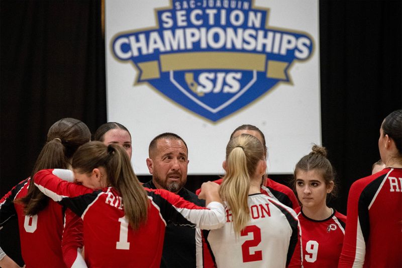 Ripon head coach Gregory Soliz, center, talks with his team during a timeout during the Sac-Joaquin Section Division III volleyball championship against Christian Brothers at Cosumnes River College in Sacramento on Nov. 8, 2025. Christian Brothers won 3-2.
