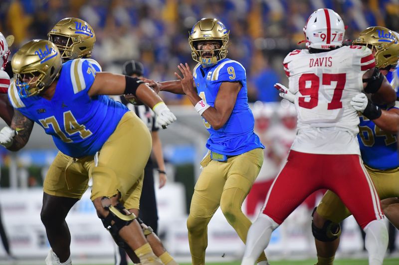 Nov 8, 2025; Pasadena, California, USA; UCLA Bruins quarterback Nico Iamaleava (9) throws against the Nebraska Cornhuskers during the first half at the Rose Bowl. Mandatory Credit: Gary A. Vasquez-Imagn Images