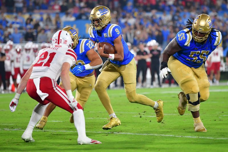 Nov 8, 2025; Pasadena, California, USA; UCLA Bruins quarterback Nico Iamaleava (9) runs the ball against the Nebraska Cornhuskers during the first half at the Rose Bowl. Mandatory Credit: Gary A. Vasquez-Imagn Images