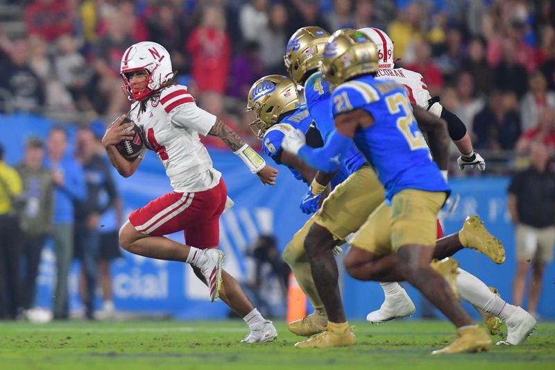 Nov 8, 2025; Pasadena, California, USA; Nebraska Cornhuskers quarterback TJ Lateef (14) runs the ball against the UCLA Bruins during the first half at the Rose Bowl. Mandatory Credit: Gary A. Vasquez-Imagn Images