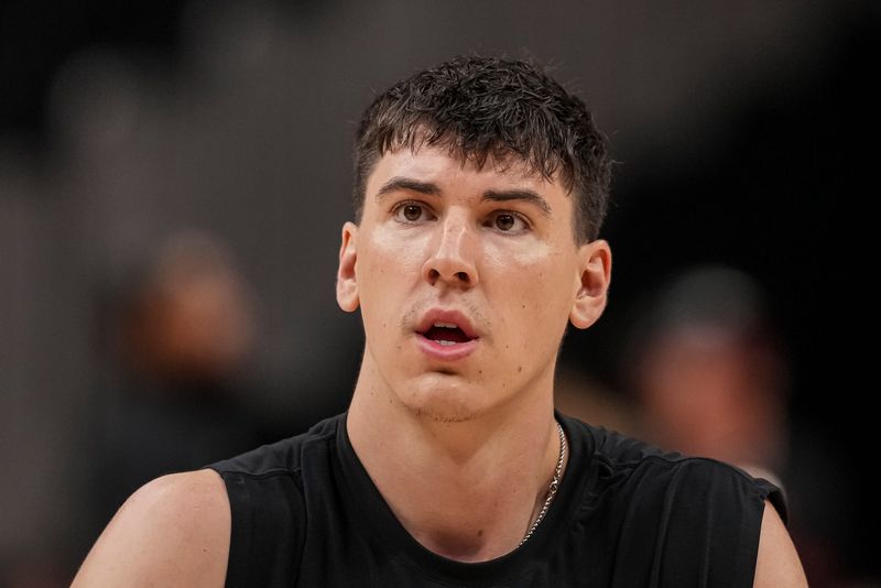 Nov 8, 2025; Atlanta, Georgia, USA; Los Angeles Lakers forward Jake LaRavia (12) warms up on the court before the game against the Atlanta Hawks at State Farm Arena. Mandatory Credit: Dale Zanine-Imagn Images