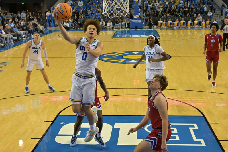 Nov 10, 2025; Los Angeles, California, USA; UCLA Bruins guard Trent Perry (0) drives past West Georgia Wolves guard Brady Hardewig (1) during the second half at Pauley Pavilion presented by Wescom Financial. Mandatory Credit: Jayne Kamin-Oncea-Imagn Images
