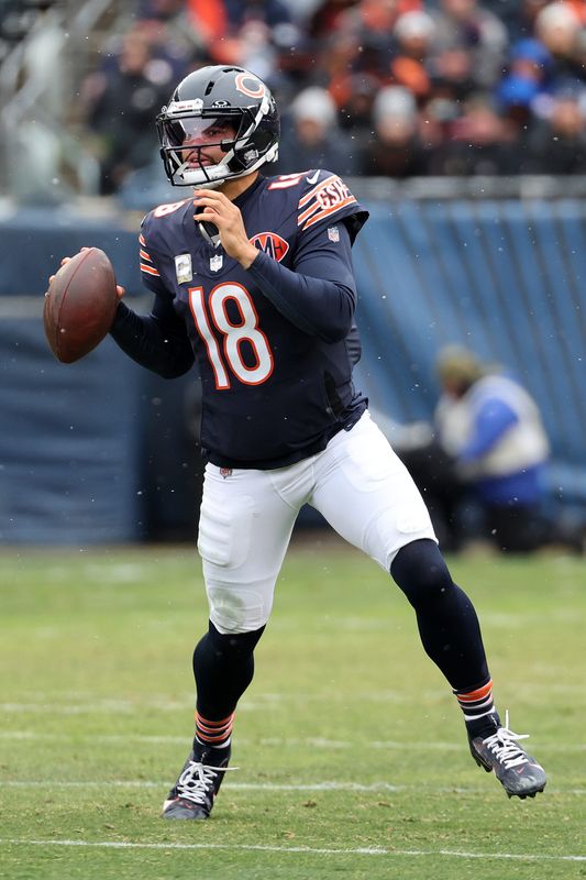Nov 9, 2025; Chicago, Illinois, USA; Chicago Bears quarterback Caleb Williams (18) drops back to pass against the New York Giants during the first half at Soldier Field. Mandatory Credit: Mike Dinovo-Imagn Images