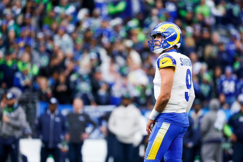 Nov 3, 2024; Seattle, Washington, USA; Los Angeles Rams quarterback Matthew Stafford (9) waits for a timeout to end against the Seattle Seahawks during the third quarter at Lumen Field. Mandatory Credit: Joe Nicholson-Imagn Images