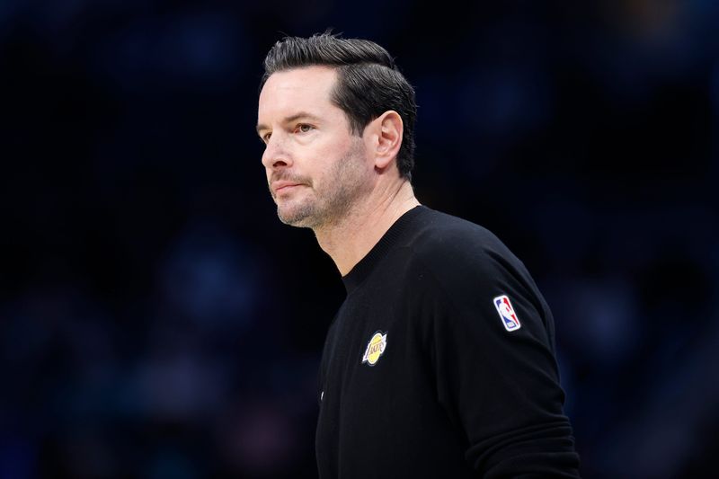 Nov 10, 2025; Charlotte, North Carolina, USA; Los Angeles Lakers Head Coach JJ Redick watches from the sideline during the first quarter against the Charlotte Hornets at Spectrum Center. Mandatory Credit: Brian Westerholt-Imagn Images