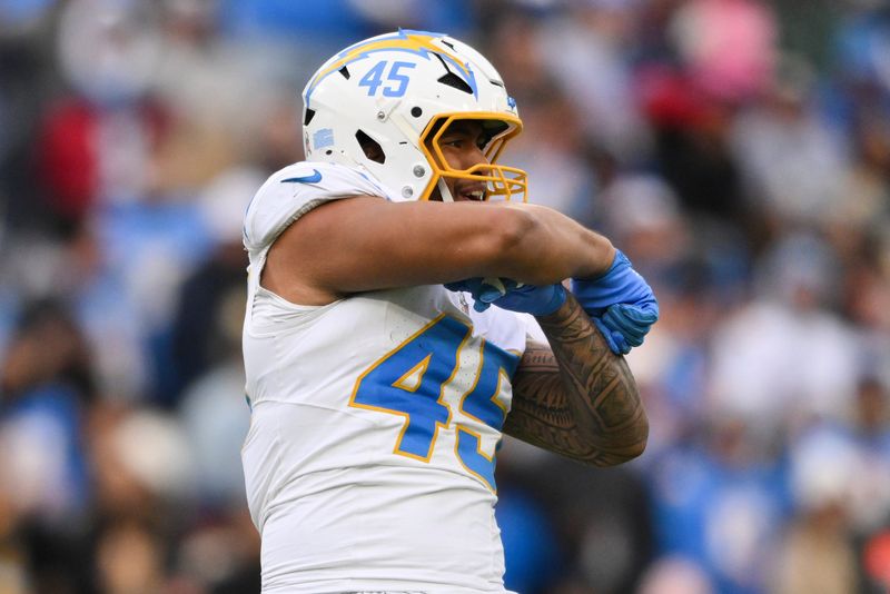 Nov 2, 2025; Nashville, Tennessee, USA; Los Angeles Chargers linebacker Tuli Tuipulotu (45) celebrates a defensive sack against the Los Angeles Chargers during the fourth quarter at Nissan Stadium. Mandatory Credit: Steve Roberts-Imagn Images