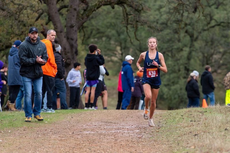 Rogue Cutler of U-Prep makes her way in the women's varsity race while her father, Nick Cutler cheers her on at the NSCIF Cross Country finals at West Valley High School on November 13, 2025.