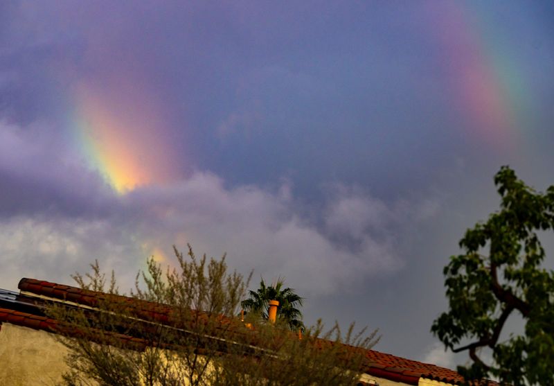 Rainbows appear between the clouds after a rain storm in Palm Desert, Calif., Saturday, Nov. 15, 2025.