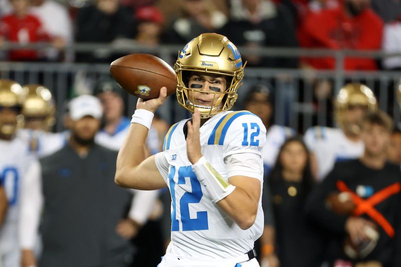 Nov 15, 2025; Columbus, Ohio, USA; UCLA Bruins quarterback Luke Duncan (12) drops back to throw during the first quarter against the Ohio State Buckeyes at Ohio Stadium. Mandatory Credit: Joseph Maiorana-Imagn Images
