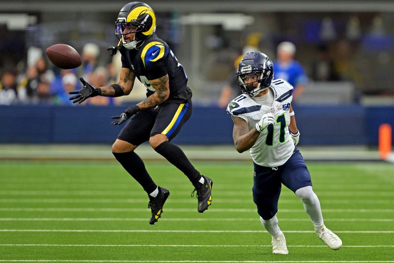Nov 16, 2025; Inglewood, California, USA; Los Angeles Rams cornerback Cobie Durant (14) makes an interception on a pass intended for Seattle Seahawks wide receiver Jaxon Smith-Njigba (11) during the second half at SoFi Stadium. Mandatory Credit: Jayne Kamin-Oncea-Imagn Images