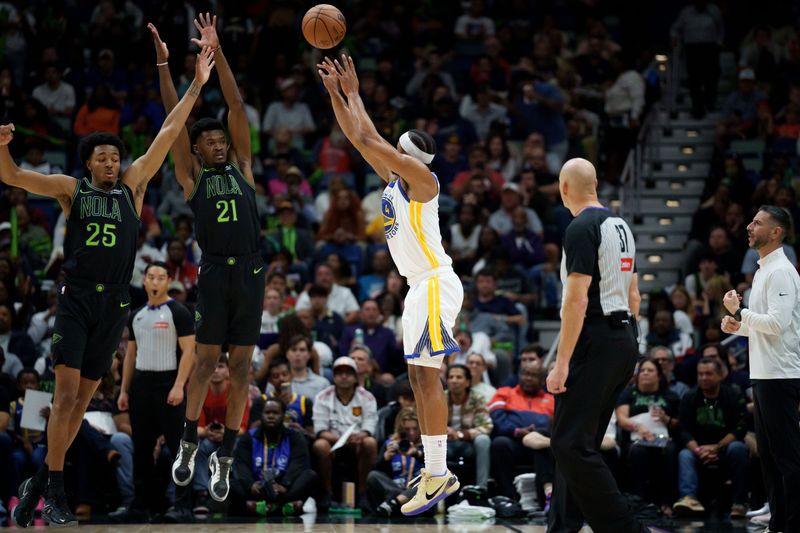 Nov 16, 2025; New Orleans, Louisiana, USA; Golden State Warriors guard Moses Moody (4) shoots a three point basket against New Orleans Pelicans forward Trey Murphy III (25) and center Yves Missi (21) during the first half at Smoothie King Center. Mandatory Credit: Matthew Hinton-Imagn Images