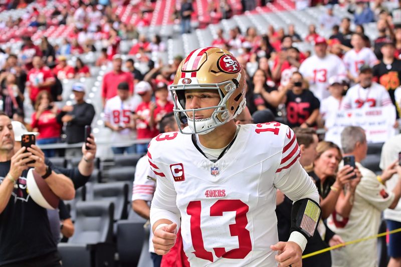 Nov 16, 2025; Glendale, Arizona, USA; San Francisco 49ers quarterback Brock Purdy (13) enters the field before the game against the Arizona Cardinals at State Farm Stadium. Mandatory Credit: Matt Kartozian-Imagn Images
