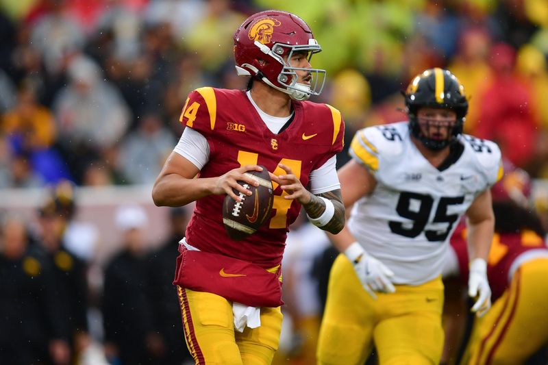 Nov 15, 2025; Los Angeles, California, USA; Southern California Trojans quarterback Jayden Maiava (14) moves out to pass against the Iowa Hawkeyes during the first half at the Los Angeles Memorial Coliseum. Mandatory Credit: Gary A. Vasquez-Imagn Images