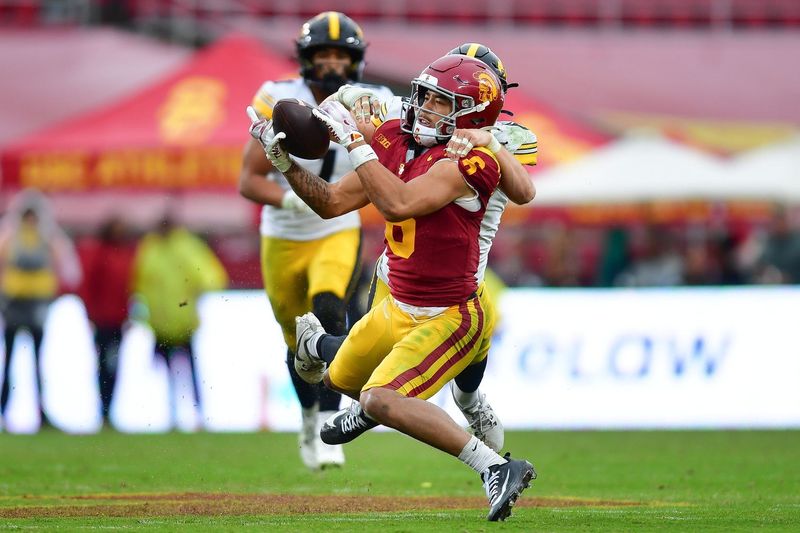 Nov 15, 2025; Los Angeles, California, USA; Southern California Trojans wide receiver Makai Lemon (6) catches a pass against the defense of Iowa Hawkeyes defensive back Zach Lutmer (6) during the second half at the Los Angeles Memorial Coliseum. Mandatory Credit: Gary A. Vasquez-Imagn Images